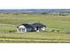 Charming home with a 2-car garage, nice landscaping, and a scenic view of rolling hills at 7600 Patrick Trl, Elizabeth, CO 80107
