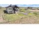 Exterior of home and horse barn on a grassy lot with mountain views at 7600 Patrick Trl, Elizabeth, CO 80107