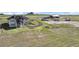Exterior view of home and barn on a large grassy lot with mountain views at 7600 Patrick Trl, Elizabeth, CO 80107