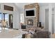 Stone fireplace with mounted TV and comfortable seating with an open floor plan at 7600 Patrick Trl, Elizabeth, CO 80107