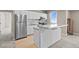 Kitchen with stainless steel appliances, white cabinets, and adjacent breakfast bar seating at 7600 Patrick Trl, Elizabeth, CO 80107