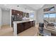 Open kitchen with dark wood cabinetry, a large island, modern appliances, and a bright window view at 7600 Patrick Trl, Elizabeth, CO 80107