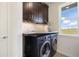 Convenient laundry room with modern washer/dryer, granite countertop, and storage cabinets at 7600 Patrick Trl, Elizabeth, CO 80107