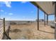 Expansive outdoor area with fencing, gravel, and a covered structure, offering ample space for livestock and activities at 7600 Patrick Trl, Elizabeth, CO 80107