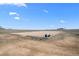 Outdoor riding arena with white fencing, well-maintained sand, and equipment, ideal for equestrian training and recreation at 7600 Patrick Trl, Elizabeth, CO 80107