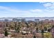 Expansive aerial view of a neighborhood with lush greenery and city skyline at 1325 S Grape St, Denver, CO 80222