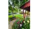 Charming backyard featuring a lush garden, vibrant flowers, and a quaint storage shed at 1325 S Grape St, Denver, CO 80222