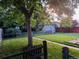 Well-maintained backyard featuring a lush lawn, mature tree, and a shed, perfect for outdoor enjoyment at 1325 S Grape St, Denver, CO 80222