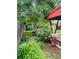 Lush backyard featuring flowerbeds, a wooden fence, and a small storage shed at 1325 S Grape St, Denver, CO 80222