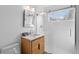 Bathroom featuring a walk-in shower, modern vanity, and a stylish mirror at 1325 S Grape St, Denver, CO 80222