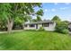 Inviting ranch-style home with a large front yard and mature trees in a peaceful neighborhood at 1325 S Grape St, Denver, CO 80222