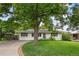 Charming single-story home with a well-manicured lawn and mature shade tree at 1325 S Grape St, Denver, CO 80222