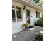 Charming home entrance featuring a decorative door with sunflowers and a welcoming 'Oh, hello' doormat at 1325 S Grape St, Denver, CO 80222