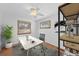 Home office with natural light, wood floors, sleek white desk, and modern shelving at 1325 S Grape St, Denver, CO 80222