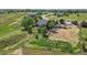 Expansive aerial view showcasing the property, including the house, large patio, shed, and surrounding landscape at 9576 E 147Th Pl, Brighton, CO 80602