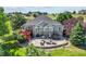 Expansive backyard featuring a stone patio with outdoor seating, hot tub, grill, and a charming raised deck at 9576 E 147Th Pl, Brighton, CO 80602