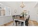 Elegant dining room with stylish chandelier, dining table and chairs, and decor at 9576 E 147Th Pl, Brighton, CO 80602