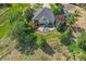 Stunning aerial view of home with patio and deck surrounded by mature trees, perfect for outdoor entertaining at 9576 E 147Th Pl, Brighton, CO 80602