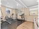 Home gym separated with glass wall adjacent to living room at 9576 E 147Th Pl, Brighton, CO 80602