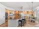 Spacious kitchen with wood cabinets, stainless steel appliances, and center island with breakfast bar at 9576 E 147Th Pl, Brighton, CO 80602