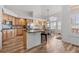 Bright kitchen with wood cabinets, center island with bar seating and adjacent breakfast nook at 9576 E 147Th Pl, Brighton, CO 80602