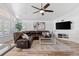 Spacious living room features a large leather sectional sofa, modern ceiling fan, and updated floors at 9576 E 147Th Pl, Brighton, CO 80602