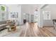 Open-concept living room with wood-look floors, and views of the office and foyer at 9576 E 147Th Pl, Brighton, CO 80602