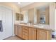 This bright main bathroom features a double sink vanity and large mirror at 9576 E 147Th Pl, Brighton, CO 80602