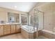 This en suite bathroom features a soaking tub, glass shower, and double sink vanity at 9576 E 147Th Pl, Brighton, CO 80602