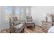 A lovely seating area is set below the bay window in the bright and airy main bedroom at 9576 E 147Th Pl, Brighton, CO 80602