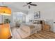 The main bedroom is bright and airy, featuring wood-look floors and a ceiling fan at 9576 E 147Th Pl, Brighton, CO 80602