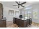 Well-lit office space with vaulted ceilings, expansive windows, and a dark wood desk at 9576 E 147Th Pl, Brighton, CO 80602