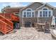 Spacious patio with grill, outdoor dining, and stairs up to a covered deck at 9576 E 147Th Pl, Brighton, CO 80602