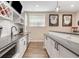 The basement bar features a stainless steel dishwasher and microwave drawer at 9576 E 147Th Pl, Brighton, CO 80602