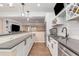 A long bar offers ample seating in this basement, complete with stainless steel appliances at 9576 E 147Th Pl, Brighton, CO 80602