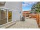 Back patio featuring stone pavers, AC unit, and sliding glass door at 16349 E Radcliff Pl # B, Aurora, CO 80015