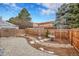 Landscaped back yard with paver patio, trees, and wood fence at 16349 E Radcliff Pl # B, Aurora, CO 80015