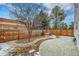 Landscaped back yard with paver patio, trees, and wood fence at 16349 E Radcliff Pl # B, Aurora, CO 80015