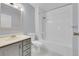 Bathroom with a shower and tub, new grey vanity, framed mirror and silver fixtures at 16349 E Radcliff Pl # B, Aurora, CO 80015