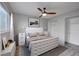 Bedroom featuring an upholstered headboard, ceiling fan, modern lighting, and a spacious closet at 16349 E Radcliff Pl # B, Aurora, CO 80015