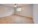 This bedroom features neutral paint, an oversized window, and wall-to-wall carpet at 16349 E Radcliff Pl # B, Aurora, CO 80015