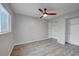 This bedroom features neutral paint, an oversized window, and a double closet at 16349 E Radcliff Pl # B, Aurora, CO 80015