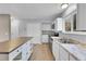 Bright kitchen featuring light cabinets, stainless steel appliances, and a large island at 16349 E Radcliff Pl # B, Aurora, CO 80015