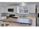 Well-lit kitchen with stainless steel appliances and a functional center island at 16349 E Radcliff Pl # B, Aurora, CO 80015