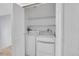 Bright laundry room with shelving and side by side washer and dryer at 16349 E Radcliff Pl # B, Aurora, CO 80015