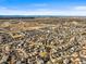 Vast aerial view of a developed suburban area showcasing numerous homes, streets, and distant landscapes at 16118 Peregrine Dr, Parker, CO 80134