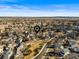 Expansive aerial view of a residential neighborhood with single-Gathering homes and well-maintained streets under a clear blue sky at 16118 Peregrine Dr, Parker, CO 80134