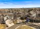 Aerial view of homes in a suburban neighborhood, featuring well-maintained yards, and mature trees at 16118 Peregrine Dr, Parker, CO 80134