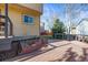 Side yard featuring wood deck, rock garden, and mature evergreens at 16118 Peregrine Dr, Parker, CO 80134