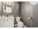 Stylish powder room with granite countertop, black faucet, and decorative painting at 16118 Peregrine Dr, Parker, CO 80134